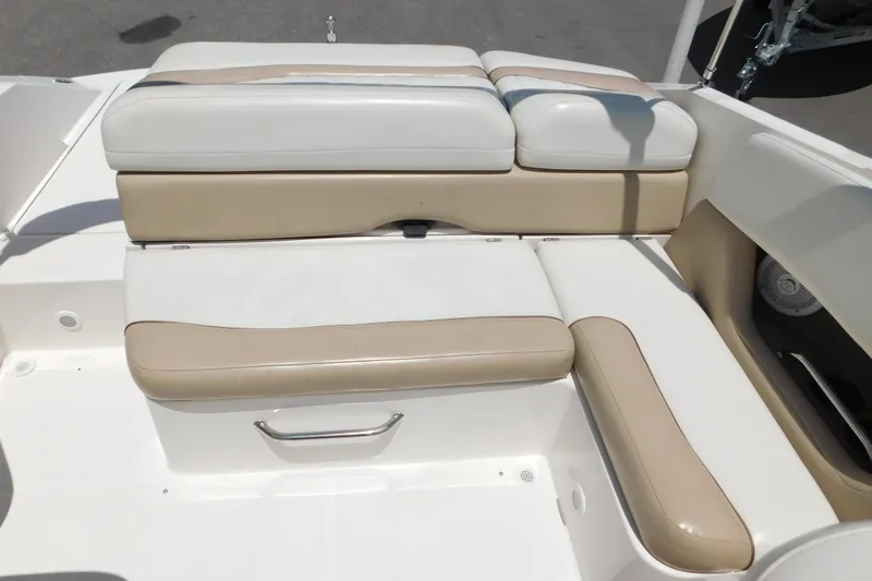 Slide: The Image of 2004 Regal 2250 LSC boat interior with beige and white cushioned seating. - 14