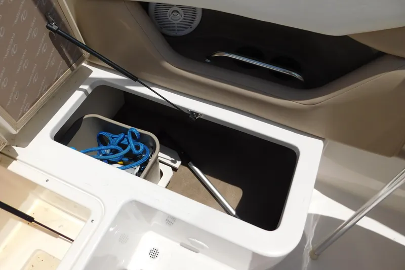 Slide: The Image of Storage compartment in a 2004 Regal 2250 LSC boat with blue rope and accessories. - 16