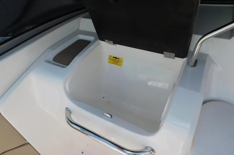 Slide: The Image of 2004 Regal 2250 LSC boat storage compartment with open lid and chrome handle. - 18
