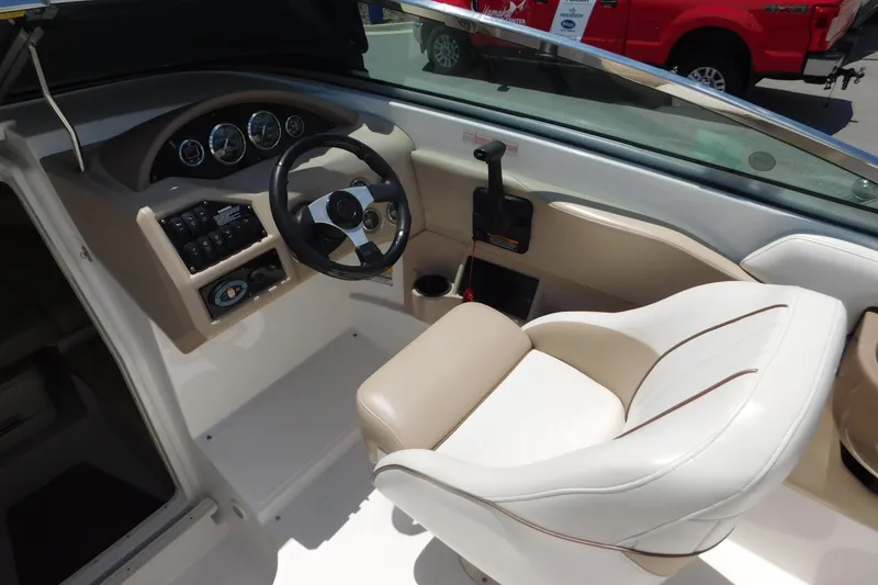 Slide: The Image of Interior of 2004 Regal 2250 LSC boat, featuring steering wheel and control panel. - 19