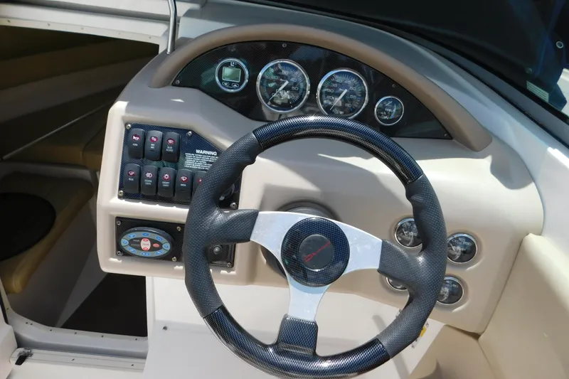 Slide: The Image of Steering wheel and dashboard of a 2004 Regal 2250 LSC boat. - 20