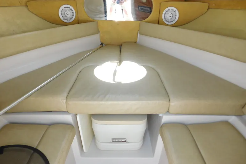 Slide: The Image of Interior of a 2004 Regal 2250 LSC boat with beige seating and storage. - 21
