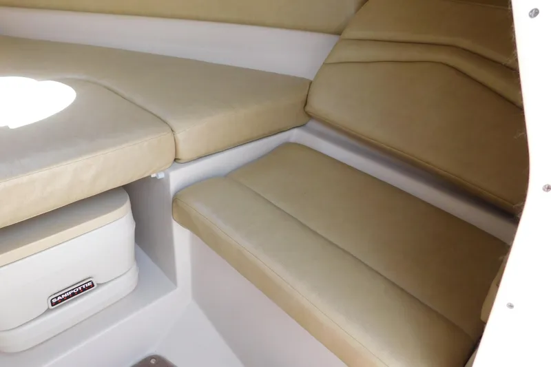 Slide: The Image of Interior cabin of 2004 Regal 2250 LSC boat with beige seating and storage. - 22