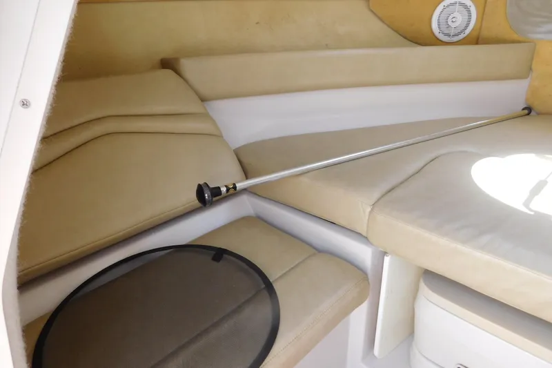 Slide: The Image of Interior of 2004 Regal 2250 LSC boat with beige seating and speaker. - 23