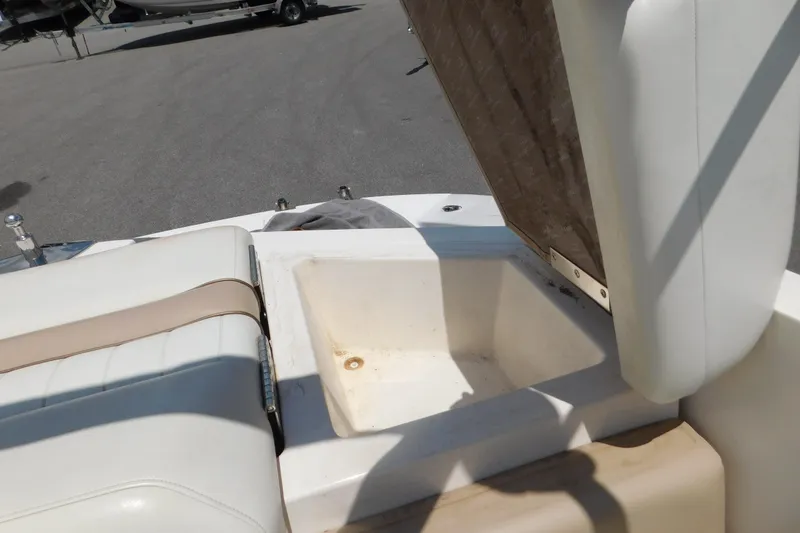 Slide: The Image of Open storage compartment on a 2004 Regal 2250 LSC boat, showing seating and interior details. - 24