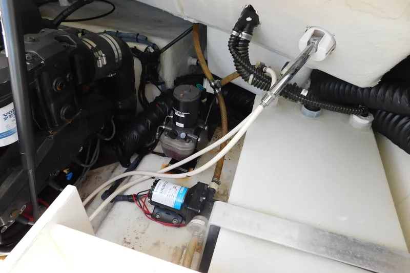 Slide: The Image of Engine compartment of a 2004 Regal 2250 LSC boat, showcasing mechanical components and wiring. - 26