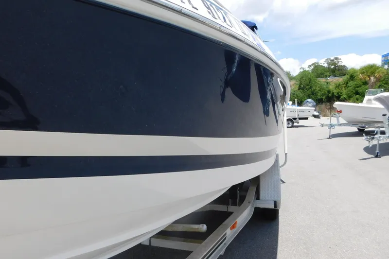 Slide: The Image of 2004 Regal 2250 LSC boat on trailer, side view with blue and white hull. - 3