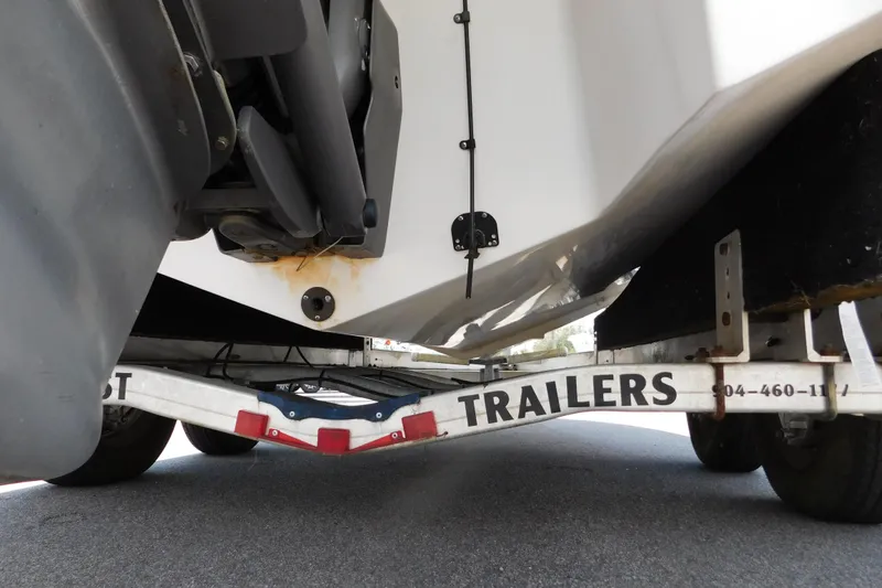 Slide: The Image of 2004 Regal 2250 LSC boat on trailer, underside view showing hull and trailer details. - 7