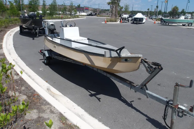 Slide: The Image of 2002 Gheenoe Classic 15 boat on trailer in parking lot, sunny day. - 2
