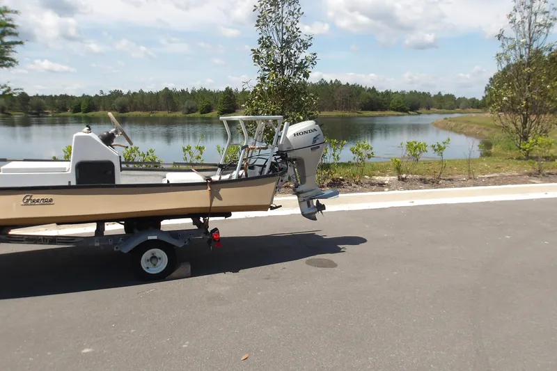 Slide: The Image of 2002 Gheenoe Classic 15 boat on trailer by a scenic lake. - 3