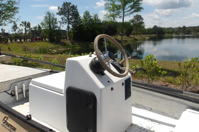 Slide: The Image of 2002 Gheenoe Classic 15 boat with steering console by a scenic lake. - 5