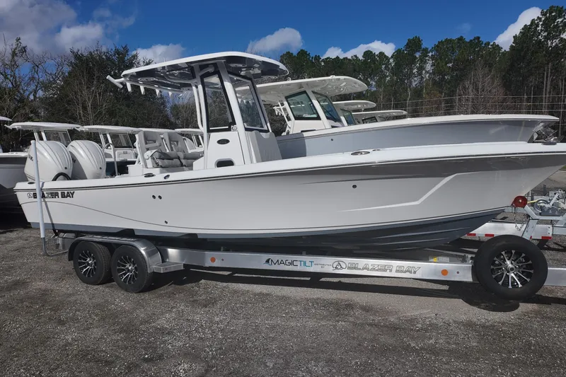 The Image of 2026 Blazer Bay Makaira 2800 boat on trailer, parked outdoors under blue sky. - 1