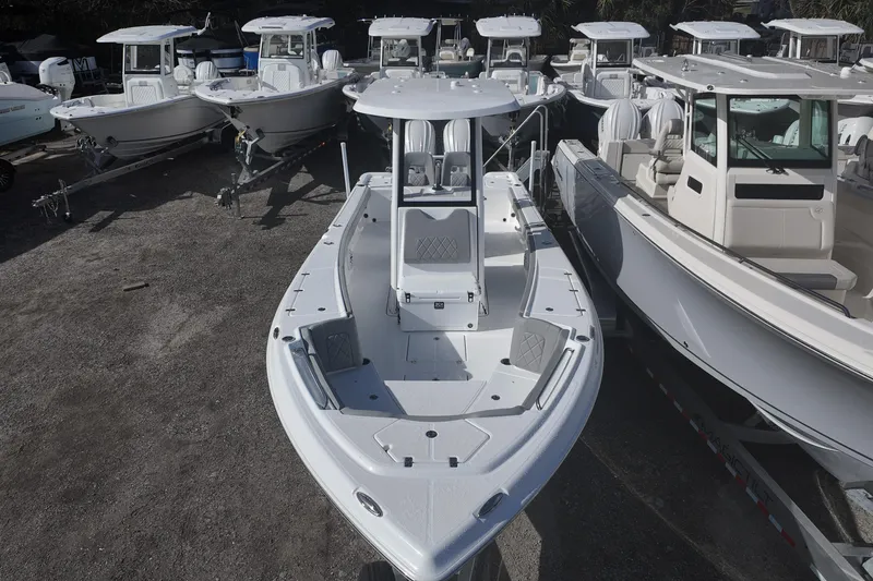 Slide: The Image of 2026 Blazer Bay Makaira 2800 boat displayed among other vessels in a marina. - 10