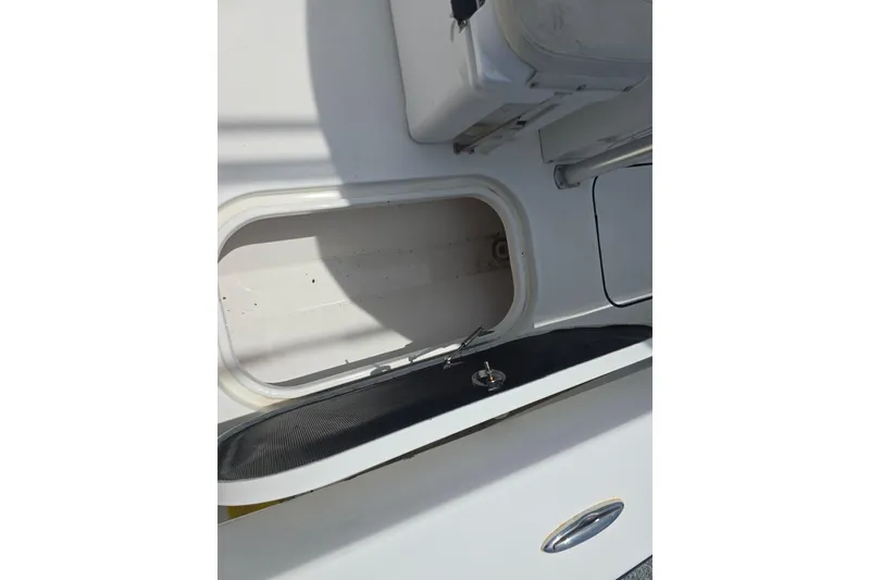 Slide: The Image of Open storage compartment on a 2015 Tideline 235 boat, showcasing interior space. - 11