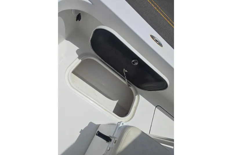 Slide: The Image of Open storage compartment on a 2015 Tideline 235 boat deck. - 12