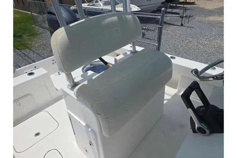 Slide: The Image of 2015 Tideline 235 boat interior with white seating and steering controls. - 13