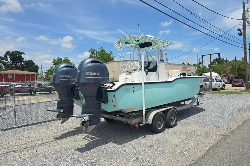 Slide: The Image of 2015 Tideline 235 boat with dual Yamaha engines on a trailer, parked outdoors. - 3