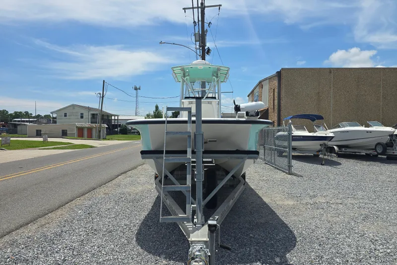 Slide: The Image of 2015 Tideline 235 boat on trailer, parked outdoors under a clear blue sky. - 6
