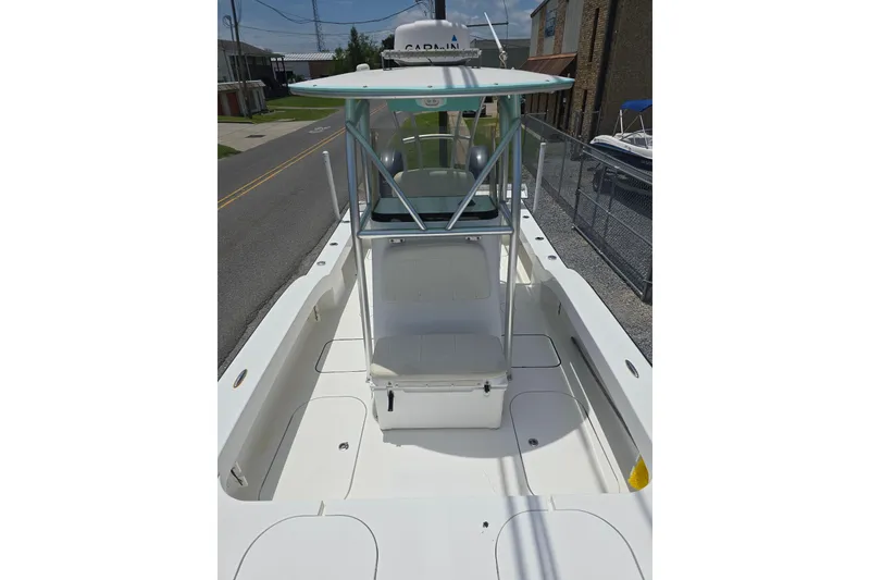 Slide: The Image of 2015 Tideline 235 boat with center console and spacious deck, docked on a sunny day. - 9