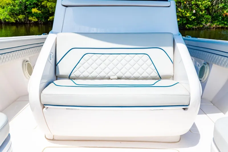 Slide: The Image of Luxurious seating on a 2018 Intrepid 327 Center Console boat, featuring elegant white upholstery. - 18