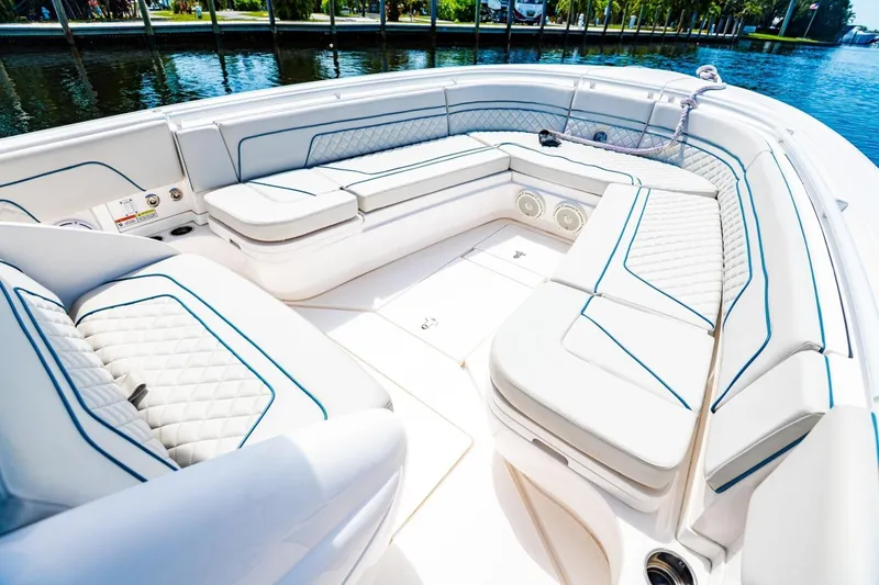 Slide: The Image of Luxurious seating on a 2018 Intrepid 327 Center Console boat, docked by the water. - 20