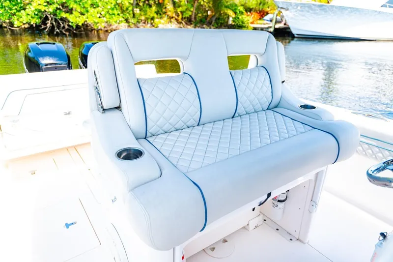 Slide: The Image of Luxurious seating on a 2018 Intrepid 327 Center Console boat, featuring quilted upholstery. - 24