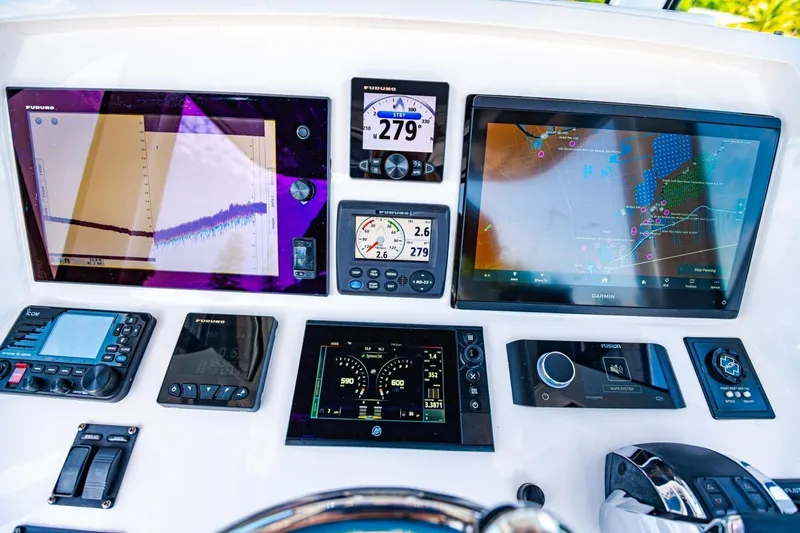 Slide: The Image of Control panel of a 2018 Intrepid 327 Center Console with advanced navigation displays. - 29