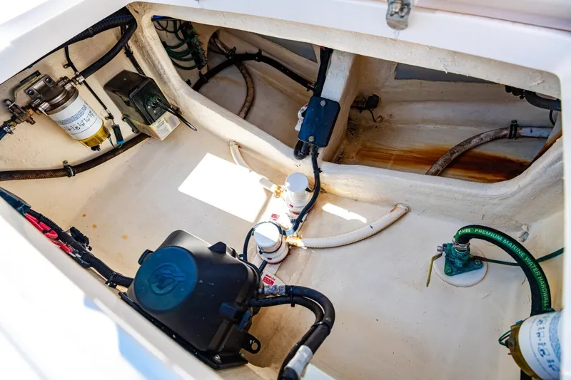 Slide: The Image of Engine compartment of a 2018 Intrepid 327 Center Console boat, showcasing various components. - 32