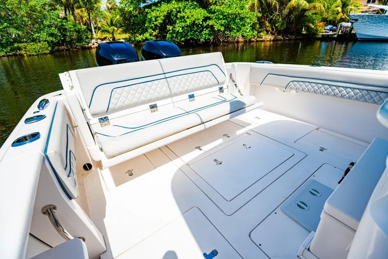 Slide: The Image of 2018 Intrepid 327 Center Console boat interior with seating and storage compartments. - 35