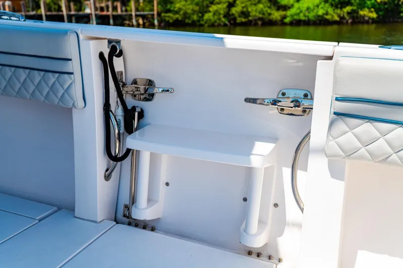Slide: The Image of 2018 Intrepid 327 Center Console boat interior with white seating and stainless steel fittings. - 37