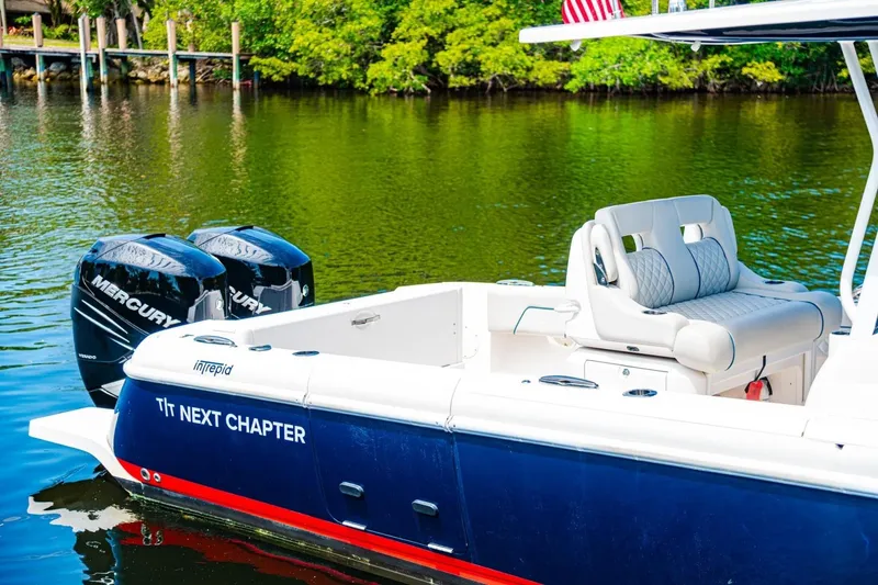 Slide: The Image of 2018 Intrepid 327 Center Console boat with Mercury engines on a calm lake. - 40