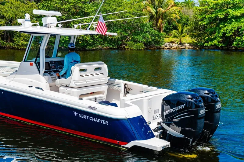 Slide: The Image of 2018 Intrepid 327 Center Console boat cruising on a scenic waterway. - 41