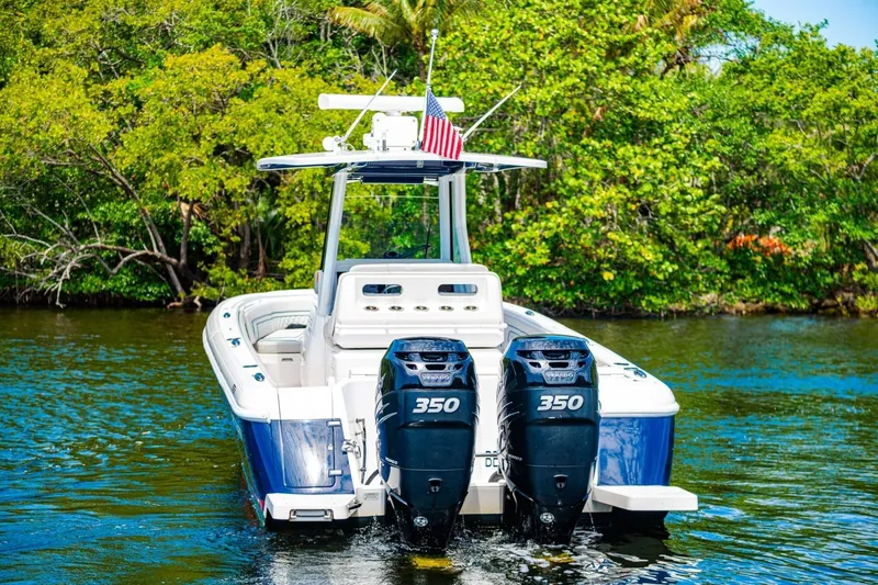 Slide: The Image of 2018 Intrepid 327 Center Console boat with twin 350 engines on a scenic waterway. - 7