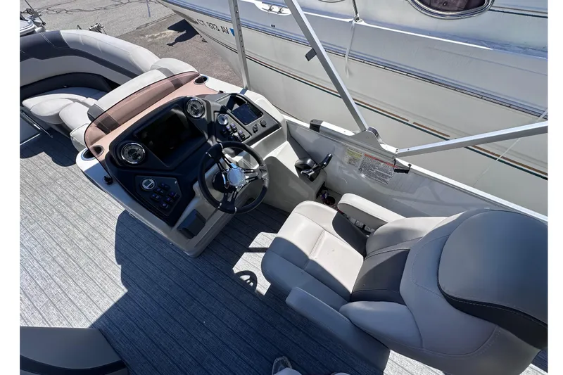 Slide: The Image of Interior view of 2022 Sylvan L1 CRS boat cockpit with steering wheel and controls. - 11