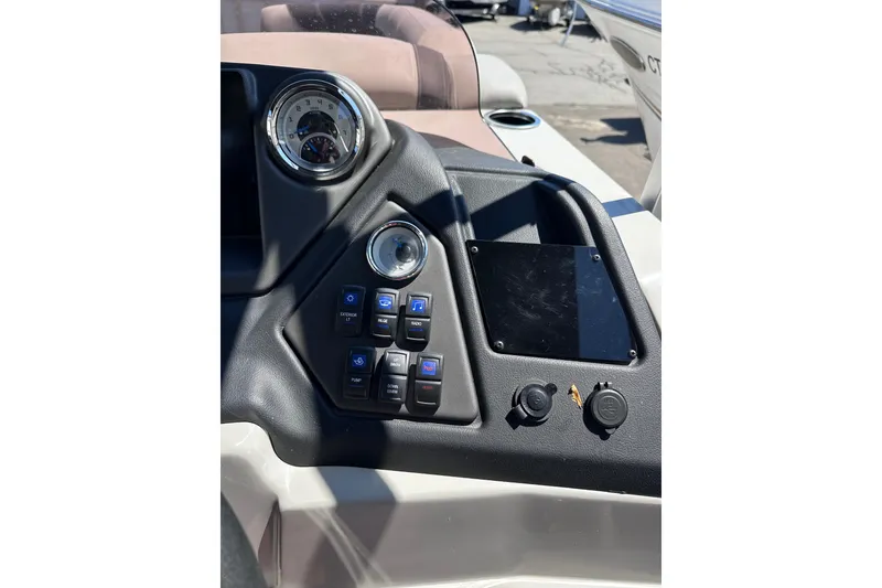Slide: The Image of 2022 Sylvan L1 CRS boat dashboard with controls and gauges in sunlight. - 13