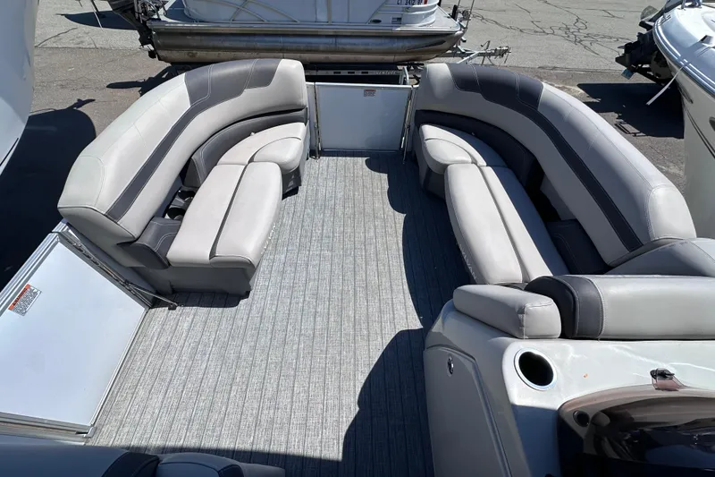 Slide: The Image of 2022 Sylvan L1 CRS pontoon boat interior with gray seating and carpeted floor. - 14