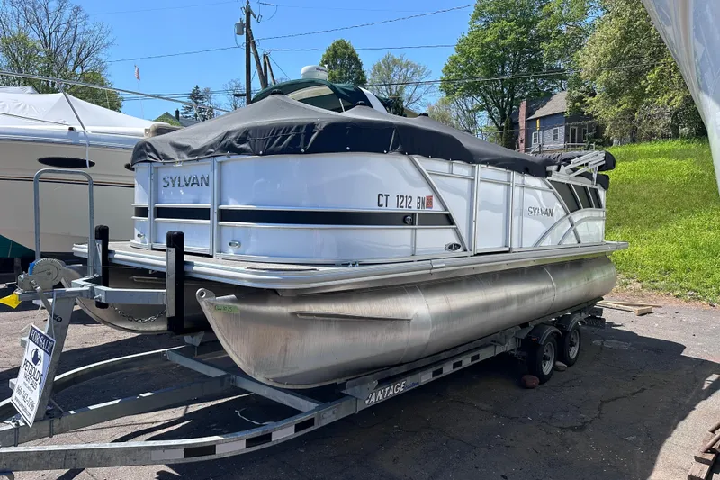 Slide: The Image of 2022 Sylvan L1 CRS pontoon boat on trailer, covered and for sale outdoors. - 18