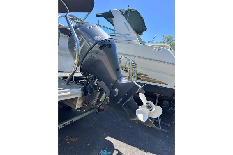 Slide: The Image of Outboard motor on a 2022 Sylvan L1 CRS boat, parked on a sunny day. - 21