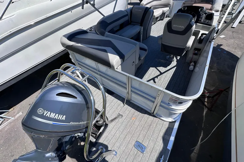 Slide: The Image of 2022 Sylvan L1 CRS pontoon boat with Yamaha outboard motor, docked. - 6