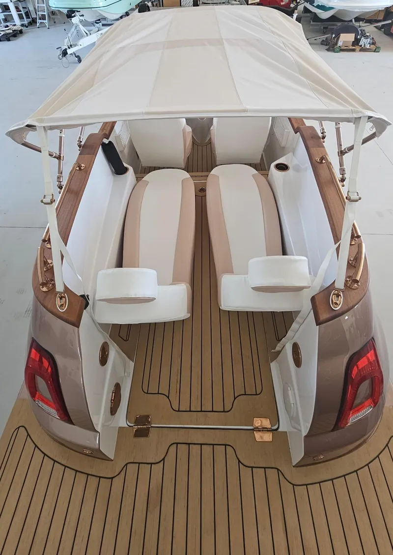 Slide: The Image of 2026 Car Off-shore Fiat 500 Rose Gold boat interior with white canopy and wooden deck. - 13