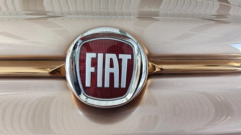 Slide: The Image of Fiat logo on 2026 Fiat 500 Rose Gold car, close-up view. - 3