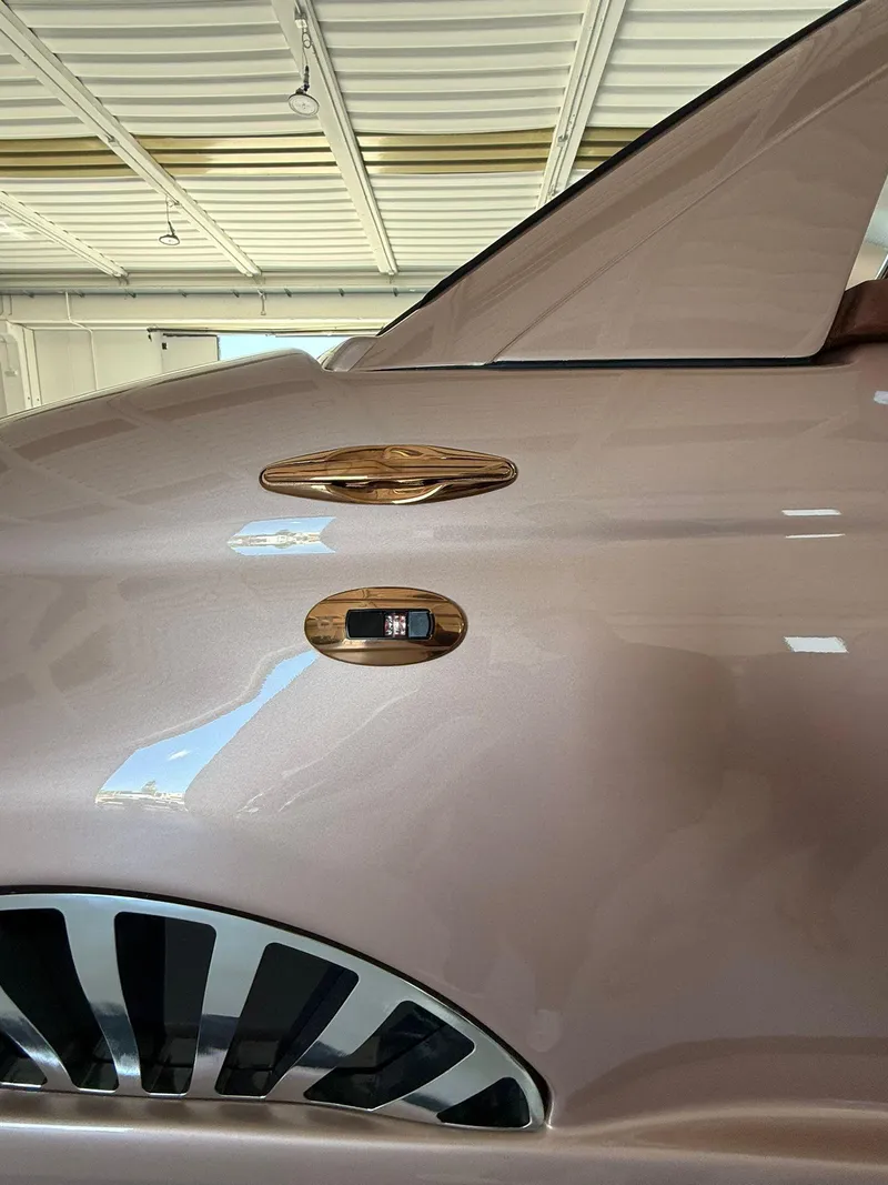 Slide: The Image of 2026 Fiat 500 Rose Gold with sleek design and modern detailing in a showroom. - 5