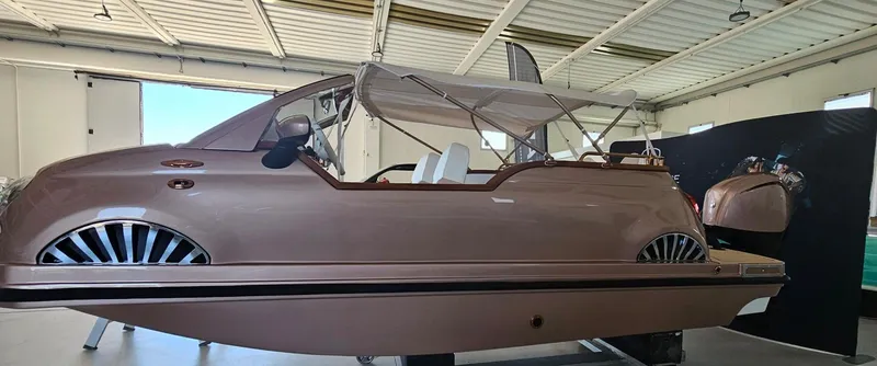 Slide: The Image of 2026 Car Off-shore Fiat 500 Rose Gold boat in a garage setting. - 6