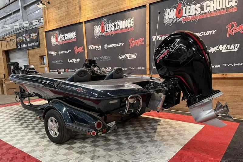 Slide: The Image of 2013 Ranger Z118 boat with Mercury engine displayed indoors at Anglers Choice. - 2