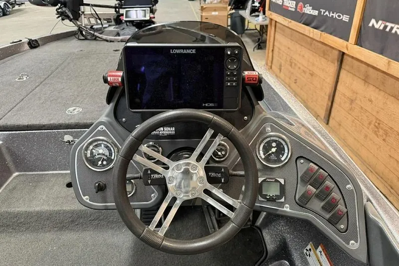 Slide: The Image of Dashboard of a 2013 Ranger Z118 boat with Lowrance electronics and steering wheel. - 4