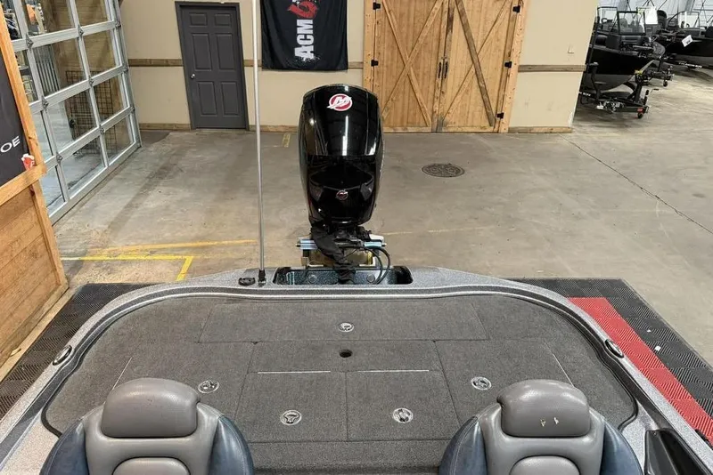 Slide: The Image of 2013 Ranger Z118 boat interior with motor in a garage setting. - 5