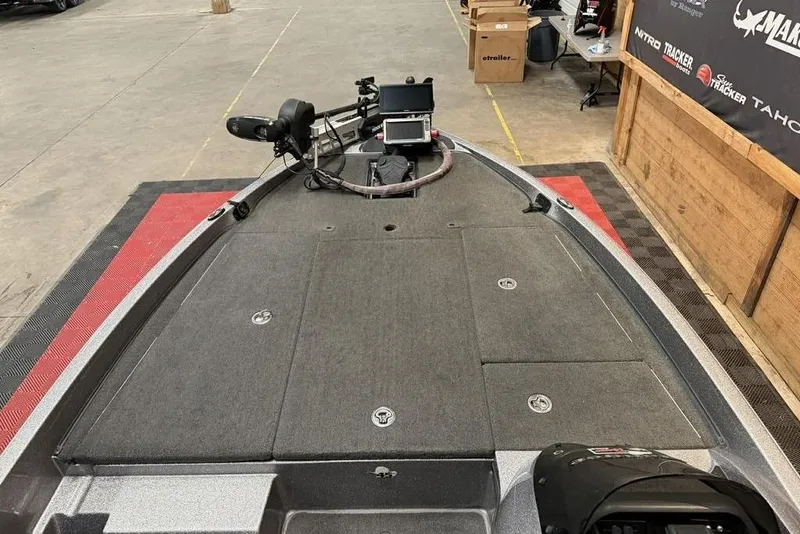 Slide: The Image of 2013 Ranger Z118 boat deck with trolling motor and electronics in a showroom. - 8