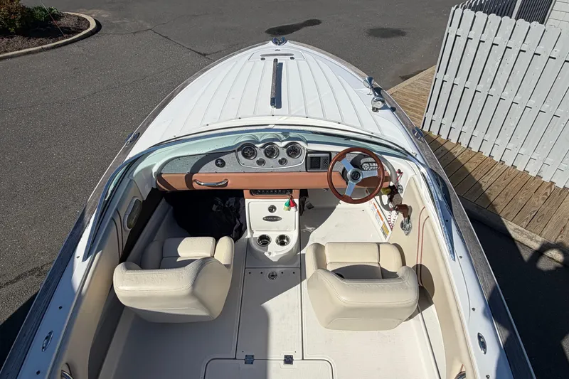 Slide: The Image of 2006 Chris-Craft Speedster boat interior with steering wheel and dashboard view. - 13