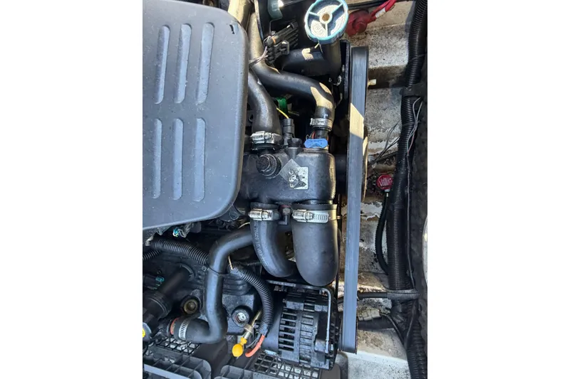 Slide: The Image of Engine components of a 2006 Chris-Craft Speedster boat, featuring hoses and clamps. - 15