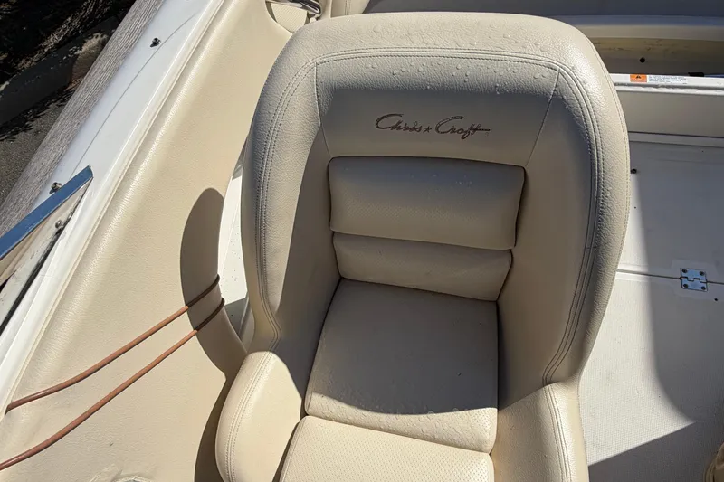 Slide: The Image of Cream leather seat in a 2006 Chris-Craft Speedster boat, featuring embossed logo. - 20